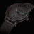 Montre pour femme avec bracelet en métal gris et cadran rond avec aiguilles vertes accentuées
