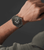 Herrenarmbanduhr am Handgelenk mit blauem Lederarmband und dunklem Zifferblatt