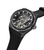 Herrenuhr schwarz, Armband mit sichtbarem Automatikwerk und Skelettzifferblatt im Detail