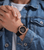 Herrenuhr am Handgelenk mit schwarzem Silikonarmband und roségoldener Lünette