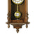 Horloge murale en bois avec balancier visible dans le compartiment inférieur, cadran rond doré