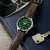 Herrenuhr mit dunkelgrünem Zifferblatt und braunem Lederarmband, silberfarbenes Gehäuse