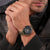 Herren-Chronograph am Handgelenk mit schwarzem Zifferblatt und olivgrünem Lederarmband
