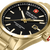 Nahaufnahme: goldene Herrenarmbanduhr, schwarzes Zifferblatt mit Indexen und Datum.