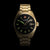 Herrenarmbanduhr mit schwarzem Zifferblatt, goldfarbenem Band, grüne Leuchtindizes.