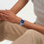 Swatch Damenuhr am Handgelenk mit hellblauem Textilband und blauem Zifferblatt