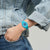 Damenuhr am Handgelenk mit türkisfarbenem Silikonarmband und blauem Zifferblatt