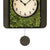 Pendule avec mousse verte, cadran en bas et poids de balancier rond