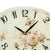 Horloge murale ronde : cadran crème avec fleurs, papillons et aiguilles noires
