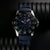 Montre homme avec bracelet bleu et cadran lumineux distinctif, boîtier en acier inoxydable avec lunette.
