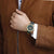 Bracelet unisexe au poignet avec cadran vert foncé et bracelet en tissu vert foncé.