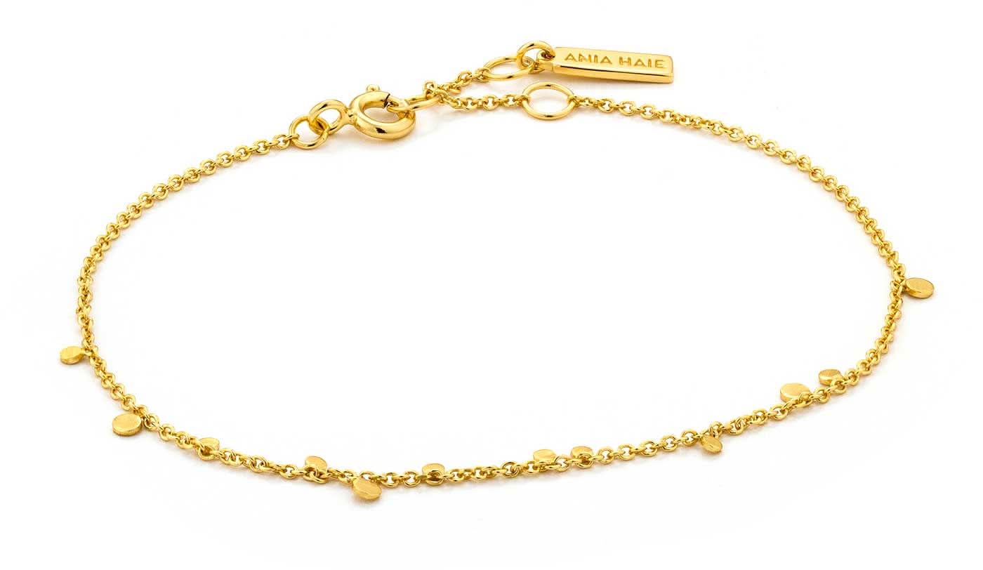 Bracelet doré avec petits pendentifs disques et maillons, fermoir