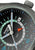 Uhr-Detail mit dunklem Zifferblatt, GMT-Sektion und roter Pfeilspitze