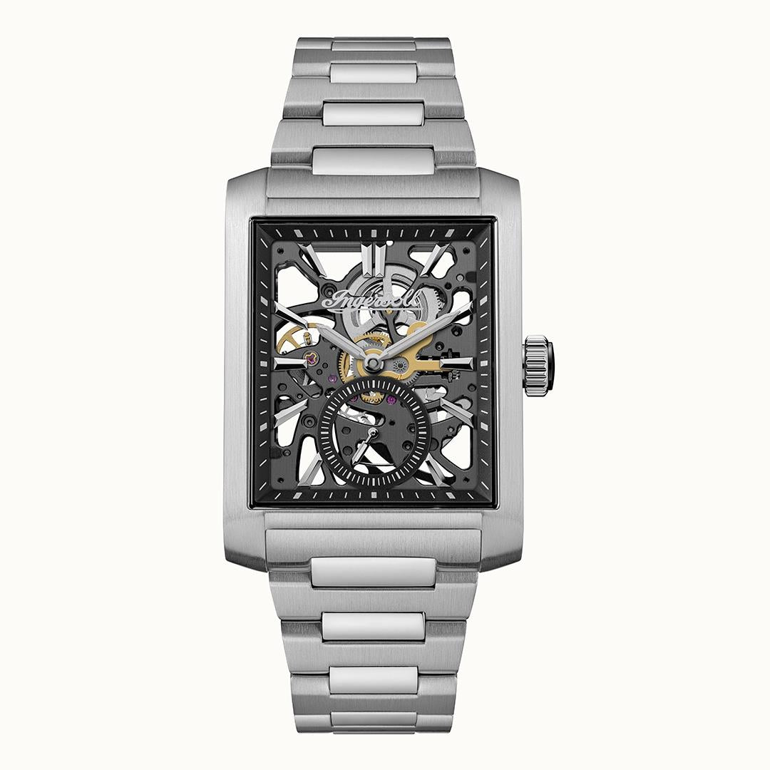 Eckige Herrenuhr mit silberfarbenem Metallarmband und skelettiertem Zifferblatt