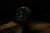 Montre Vostok Europe pour homme avec chiffres et aiguilles verts lumineux sur cadran sombre