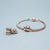 Charm en acier inoxydable plaqué or rose sur bracelet tressé avec détails en cœur