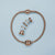 Bracelet gourmette en acier inoxydable avec fermoir en or rose et breloques individuelles