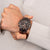 Festina Chronograph am Handgelenk mit braunem Zifferblatt und Metallarmband in Schwarz-Braun