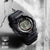 Montre G-Shock pour homme avec affichage numérique, boîtier noir avec inscription « Shock Resist »