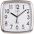 Quadratische Wanduhr mit weißem Zifferblatt, schwarzen Zeigern und Ziffern, JVD-Logo