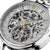Montre homme avec cadran squelette, aiguilles dorées et touches bleues