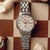 Montre pour femme avec bracelet en acier inoxydable argenté, cadran clair et couronne dorée