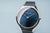 Armbanduhr mit blauem Zifferblatt, schmalem Edelstahlgehäuse und Milanaiseband