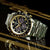 Herrenarmbanduhr mit schwarzem Zifferblatt, Tachymeter-Lünette und Edelstahlband