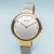 Montre pour femme avec bracelet milanais argenté, lunette dorée, cadran blanc