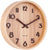 Horloge murale ronde en bois avec cadran et aiguilles noirs, vue de côté