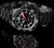 Montre de plongée avec cadran noir, aiguilles rouges, index luminescents et bracelet en acier inoxydable
