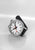 Montre pour homme avec bracelet en cuir noir, boîtier rond argenté et cadran blanc