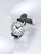 Montre homme avec bracelet en cuir noir, boîtier argenté et cadran blanc