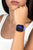 Montre connectée au poignet avec bracelet violet et cadran rond affichant l'heure