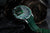 Montre de plongée avec cadran vert, boîtier argenté et bracelet en silicone vert