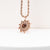 Collier avec chaîne torsadée en or rose et pendentif soleil en bois foncé