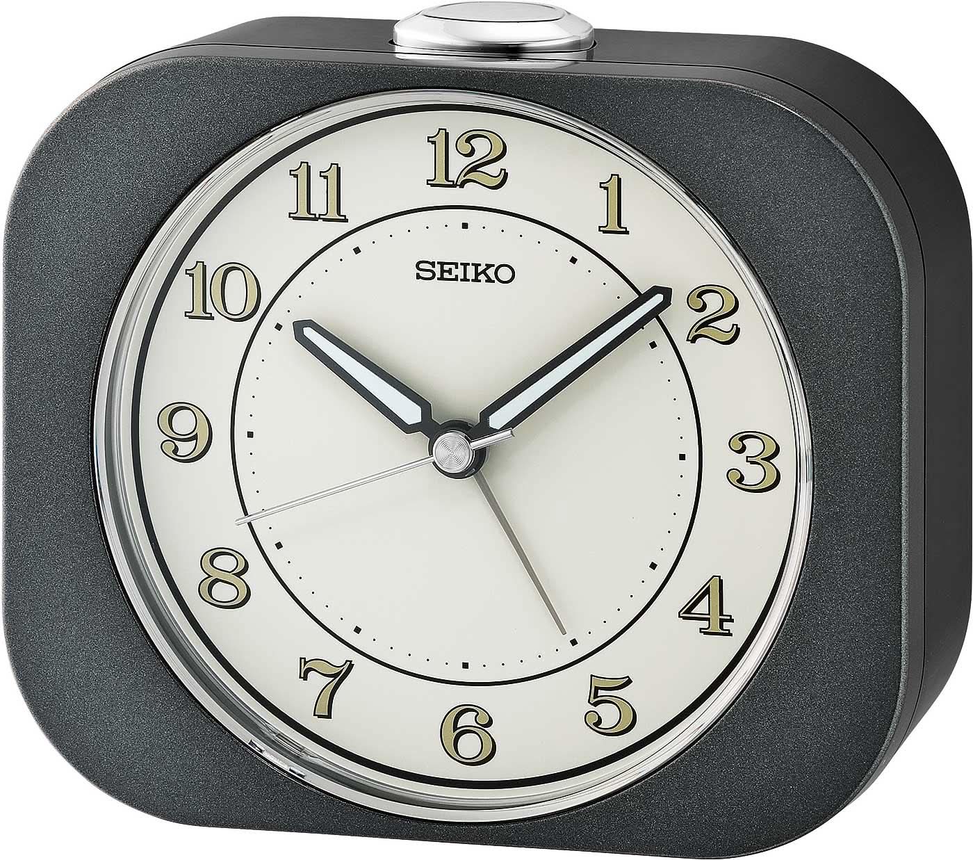 Réveil analogique Seiko avec cadran blanc rond et boîtier en plastique foncé