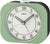 Réveil classique Seiko avec boîtier rond en plastique vert, cadran blanc et aiguilles analogiques