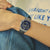 Herrenarmbanduhr am Handgelenk mit blauem Zifferblatt und Stahllinkarmband