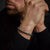 Bracelet en perles de pierre naturelle grise au poignet avec fermoir en acier inoxydable