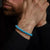 Bracelet en perles de turquenite turquoise au poignet, avec fermoir en acier inoxydable