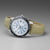 Montre homme avec bracelet en cuir beige, cadran argenté, lunette bleue et index