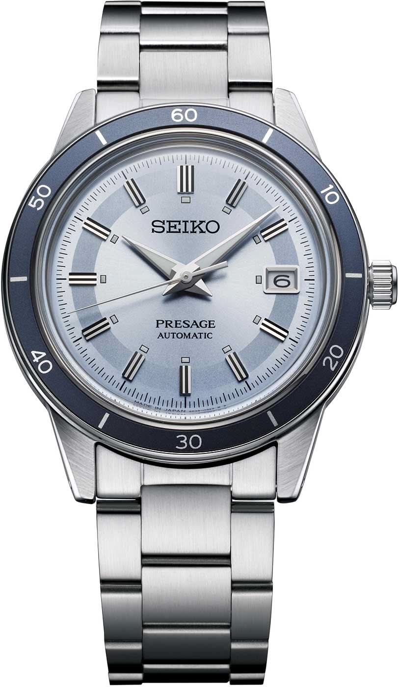 Montre homme avec bracelet en métal, cadran argenté et lunette/échelle bleue, affichage de la date