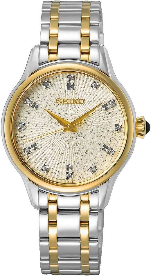 Montre pour femme avec bracelet bicolore en métal, lunette dorée et cadran argenté à motifs