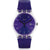 Swatch Damenuhr mit rundem violettem Zifferblatt, silbernem Gehäuse und Glitzerarmband