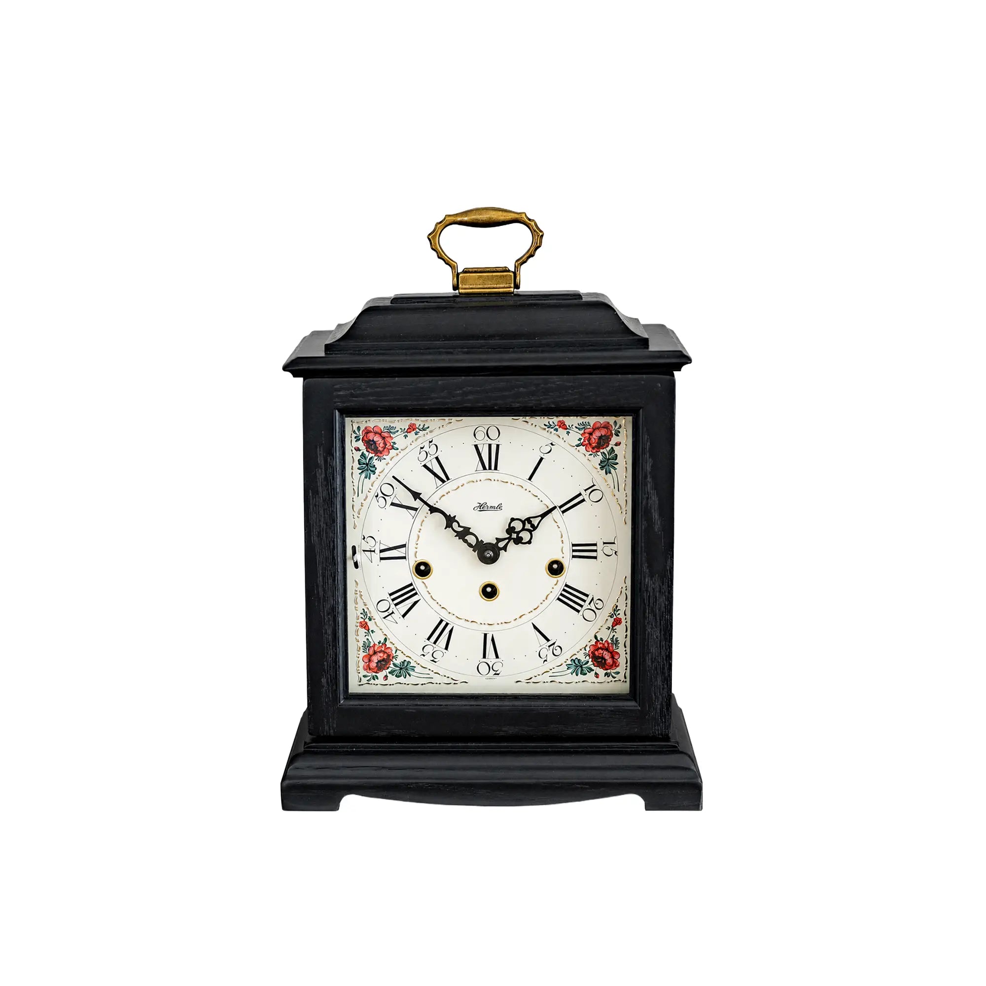 Horloge de table noire avec cadran floral et poignée dorée, remontage mécanique