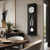 Horloge murale avec cadre noir, façade en verre, cadran rond et barres sonores en acier inoxydable
