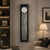 Horloge murale avec cadre noir, cadran rond et pendule en métal sous verre