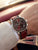Zeppelin Chronograph am Handgelenk, dunkelrotes Lederarmband, rundes Gehäuse