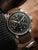 Zeppelin Herrenuhr Chronograph am Handgelenk, braunes Lederband, schwarzes Zifferblatt